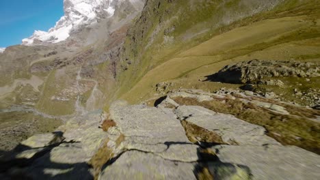 Aerial-fpv-drone-flying-over-alpine-mountain-rocky-surface-of-Cima-Fontana-in-Valmalenco