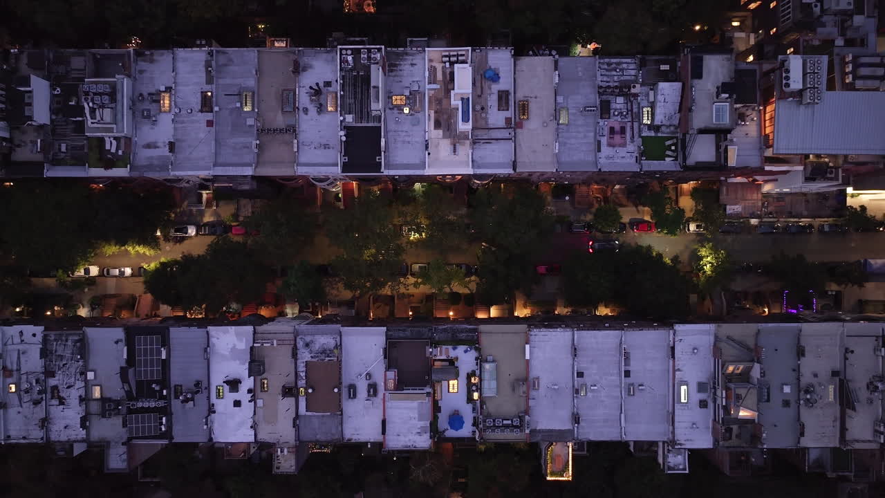 Aerial view looking down at a row of Brownstones on Manhattan's Upper West Side at night. Shot in New York City in 4k.