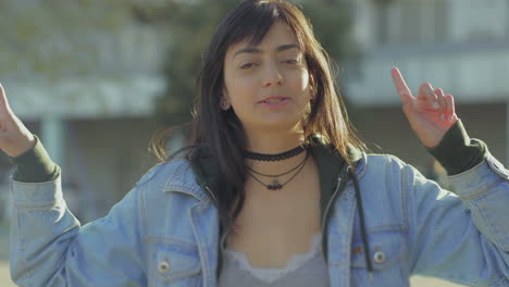 Cheerful-teen-girl-looking-at-camera-and-waving.