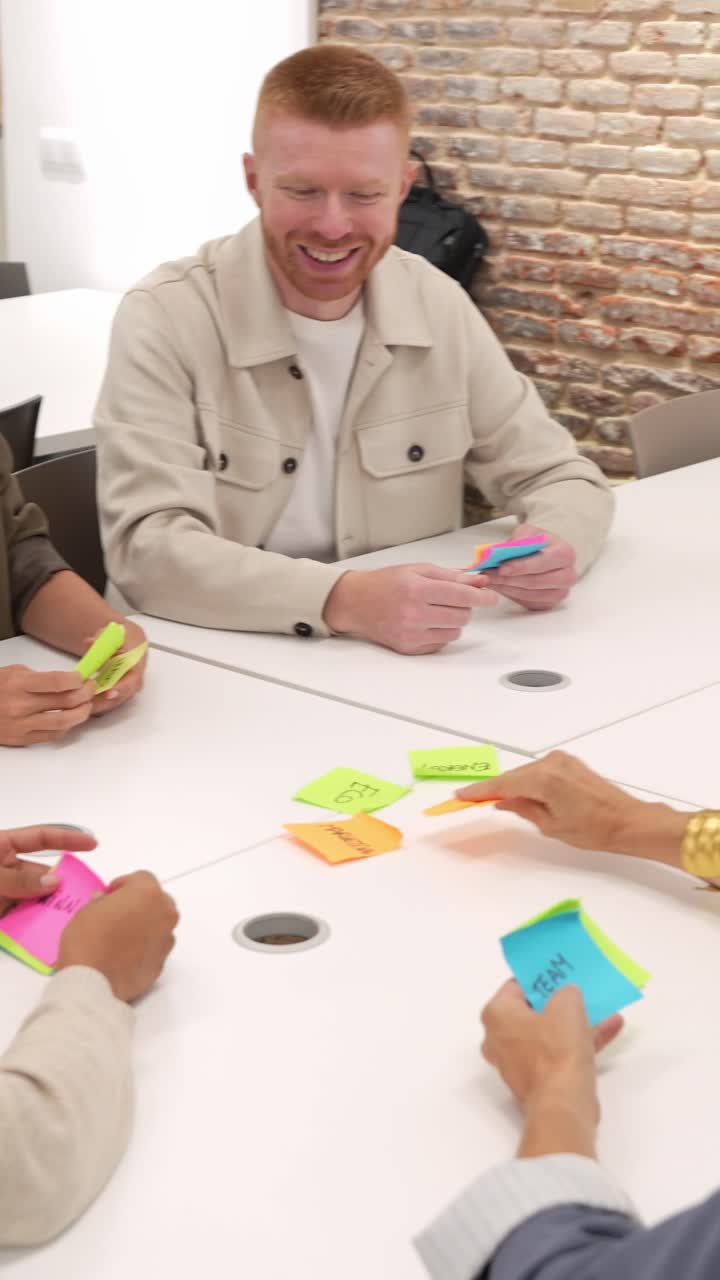 Happy Business Team Playing a Creative Sticky Note Game