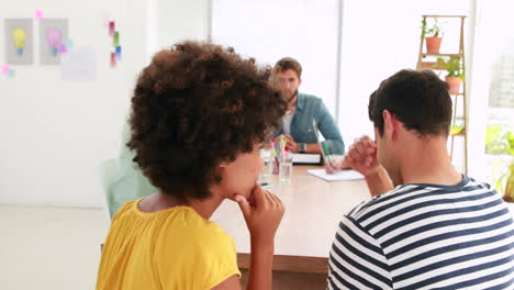 Two-casual-business-worker-chatting-during-meeting