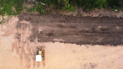 Aerial-view-of-a-tractor-and-a-grader-to-level-the-ground-in-the-construction-of-a-residential-house