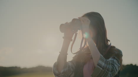 young woman exploring through binocular