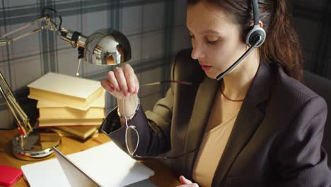 woman woman working long hours - she takes off her eyeglasses. she has a strong headache.