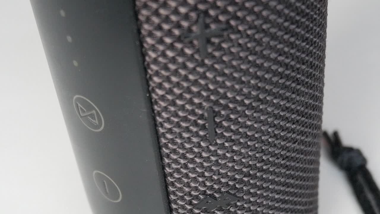 Close-up of a Bluetooth speaker with textured surface indoors