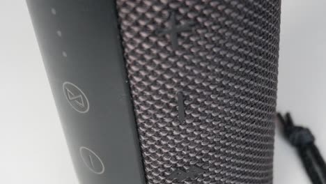 close-up of a bluetooth speaker with textured surface indoors