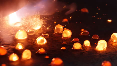 close-up of molten material droplets reacting to intense heat