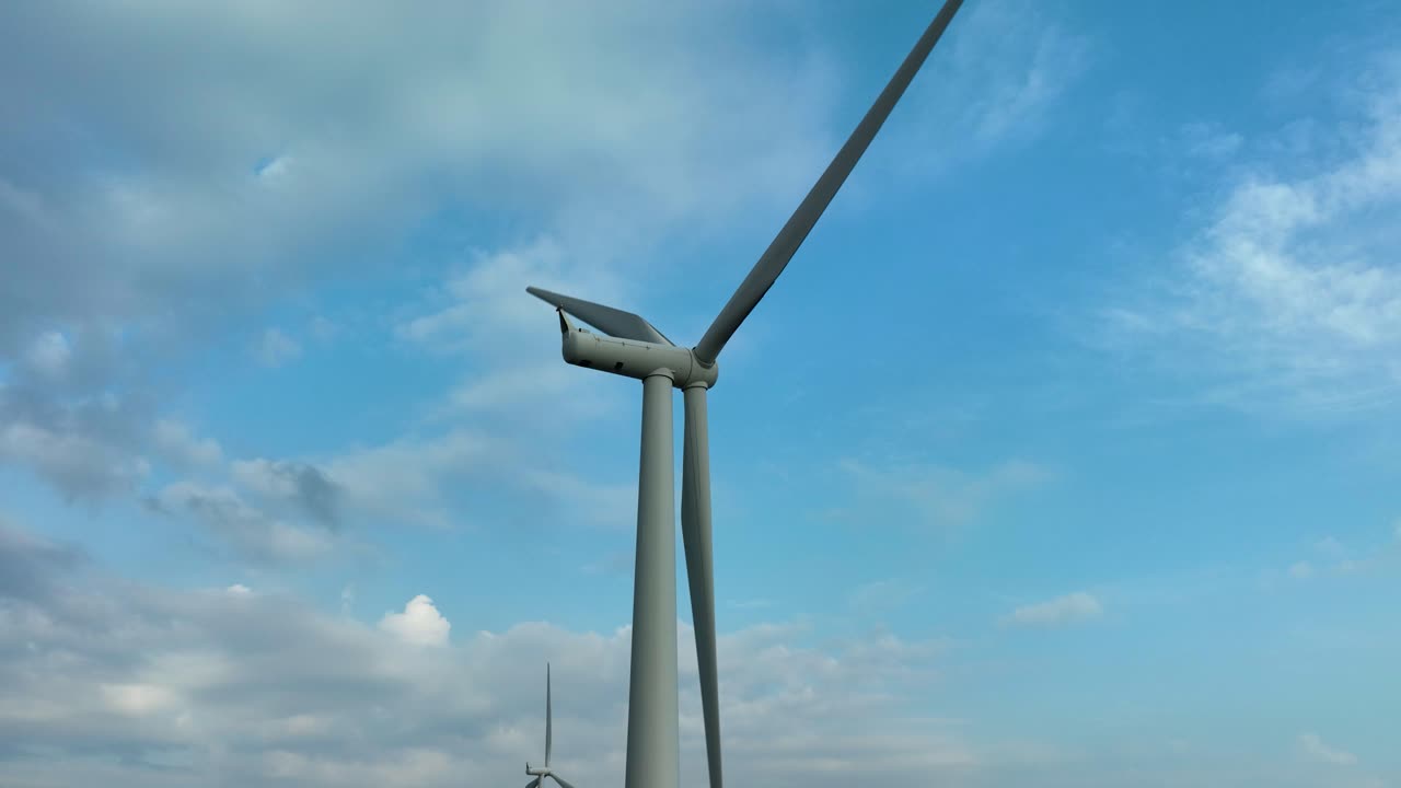 Drone captures rotating turbines producing renewable energy in Lista.
