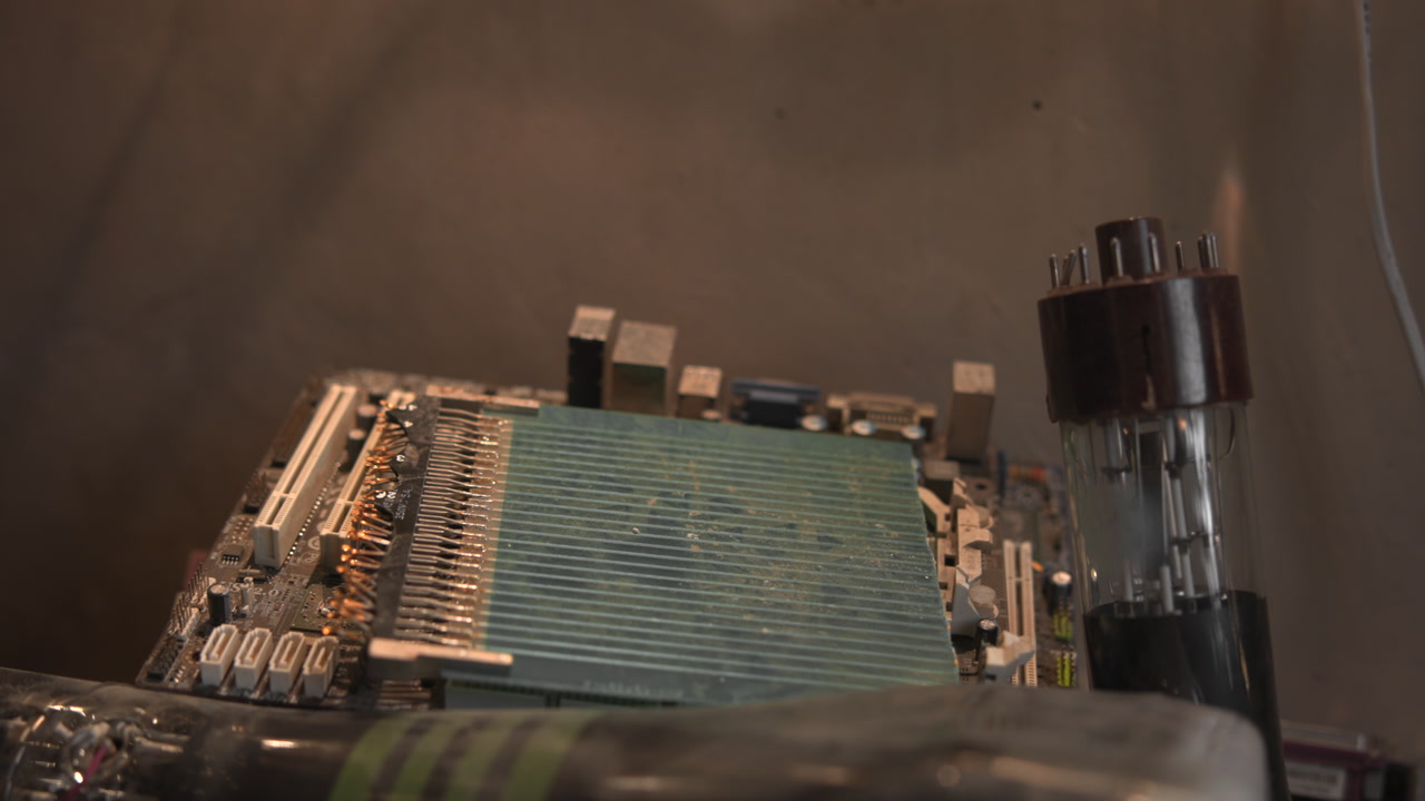 Closeup Vintage Circuit Board With Tube, Warmlit Workshop Scene Showing Aged PCB, Glass Vacuum Tube, Solder . Media