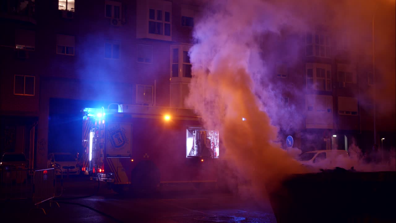Fire Truck with Flashing Lights and Smoke in Urban Night
