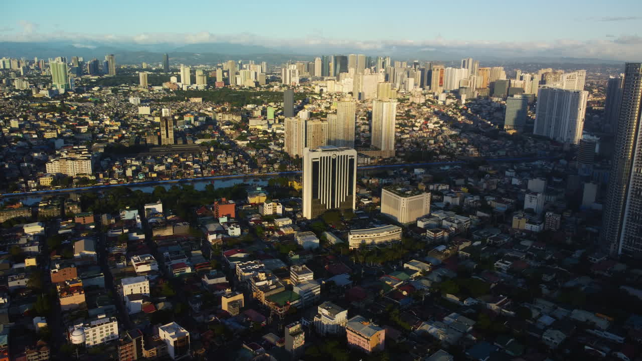 Aerial overview Barangays of Makati and Mandaluyong, sunny evening in Manila, Philippines