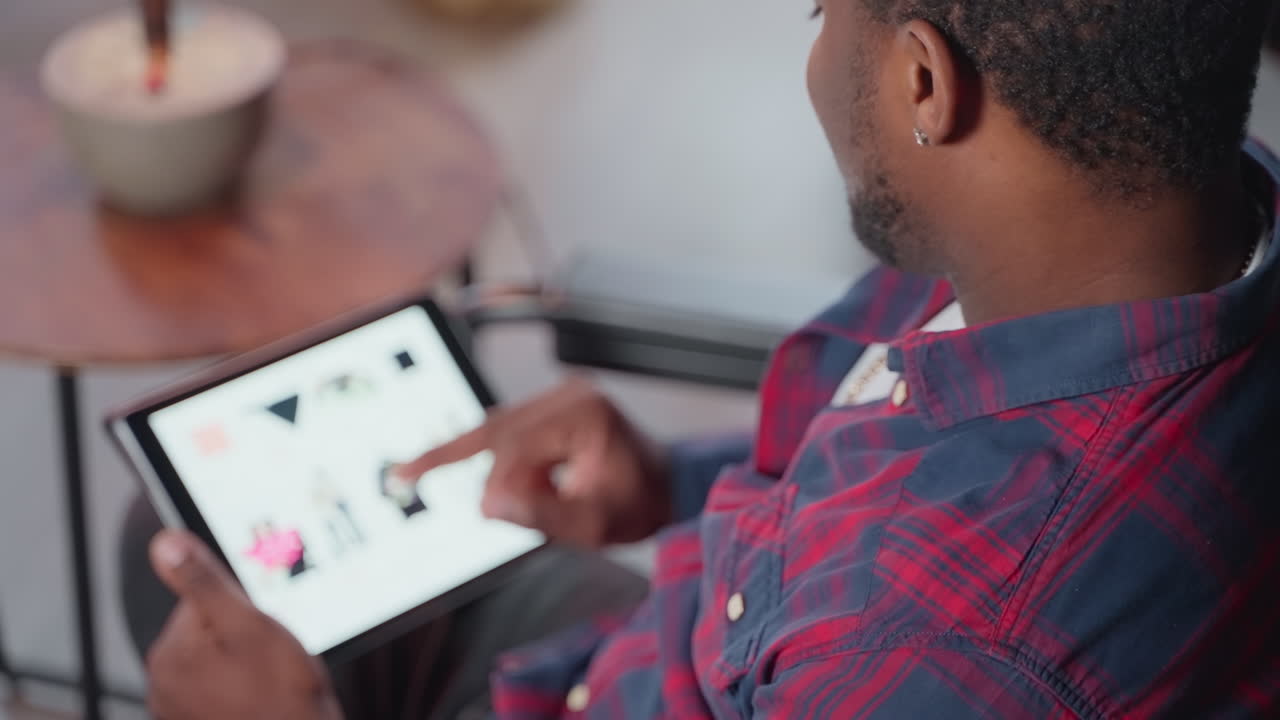 Man Browsing Clothing Online on Tablet