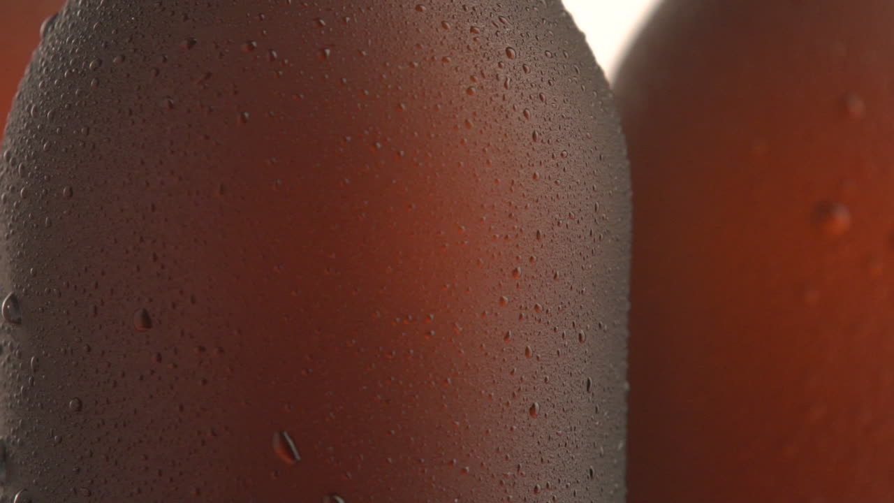 Three beer bottle rotating on black background