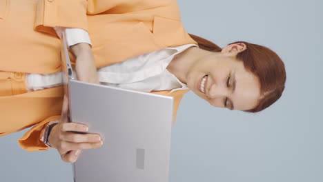 Vertical-video-of-Business-woman-relaxes-after-finishing-her-work-on-laptop.