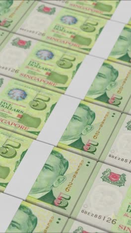 vertical video of 5 singapore dollar banknotes printed by a money press