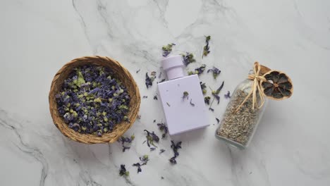 purple perfume and dried flowers arrangement