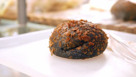 Black--coconut-bun-on-table-,
