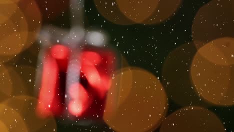 animación de la nieve cayendo sobre la decoración de regalo de navidad roja