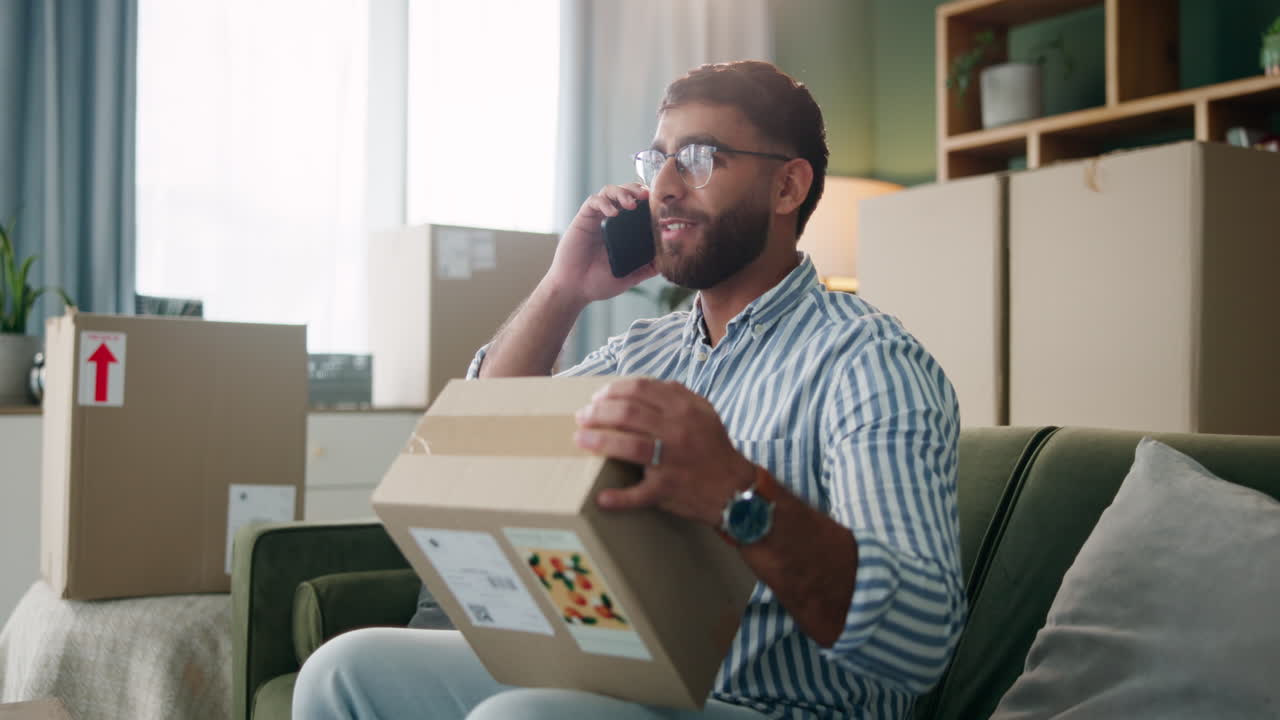 Man talking on the phone with a package