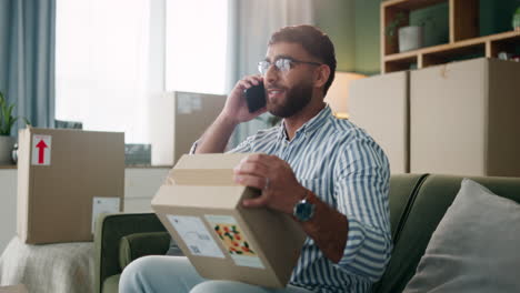 man talking on the phone with a package