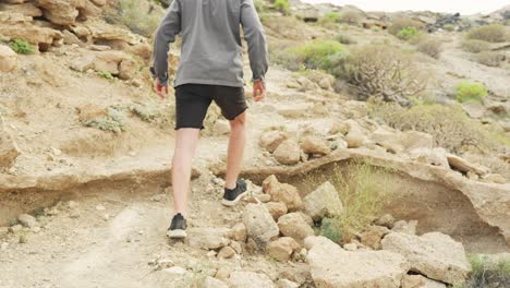 young traveler slips on rocky terrain barely avoiding injuries