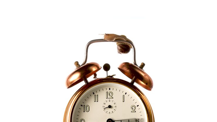 CLock hand spinning fast time lapse. Clock hand spinning fast on vintage bronze alarm-clock on white background.