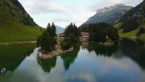 the reflection of the sky in the water disturbed by a small boat in the romantic scenery in the swiss alps