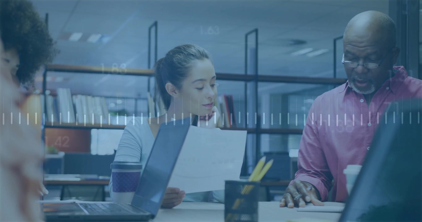 Woman reviewing report while man pointing line causing waveform pulsing in business meeting