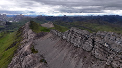 Cinematic aerial view of snowy Andes mountains in Peru with glaciers, rocky cliffs, and hidden blue alpine lake under misty clouds, dramatic landscape and natural travel destination