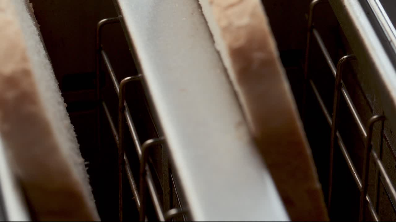 Toasting Two Slices of Bread Inserted in Kitchen Toaster Slots