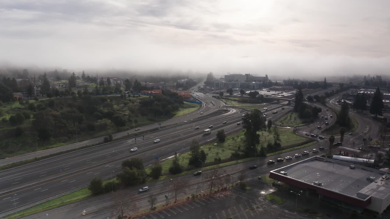 Aerial low rising shot of Highway 101 on a foggy morning in Santa Rosa, California. 4K