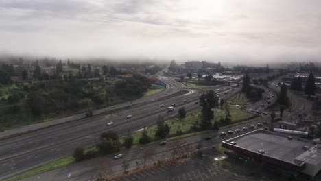 aerial low rising shot of highway 101 on a foggy morning in santa rosa, california. 4k