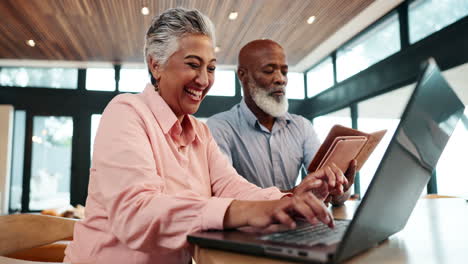 older adults working together on a laptop
