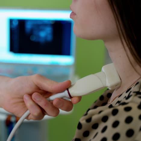 ultrasound diagnostic of thyroid gland. doctor examining woman's organ in clinic. ultrasonic scanner on female's neck during medical procedure. close-up.
