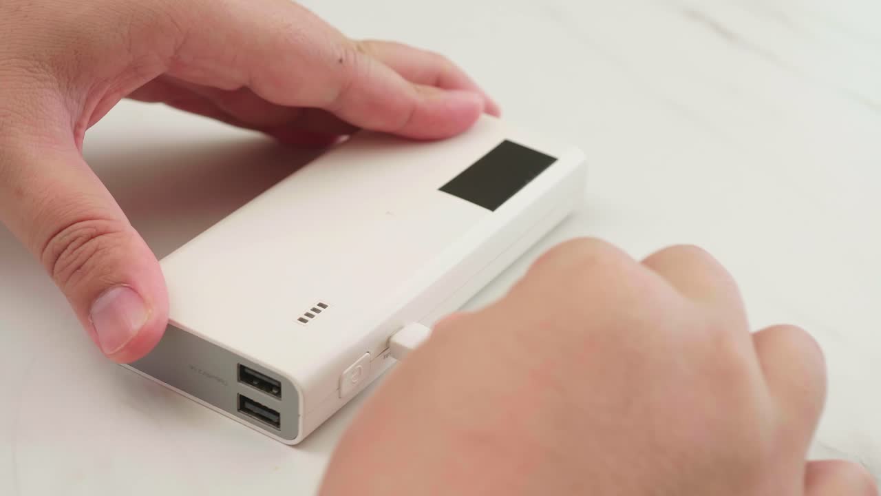 Man connect cable for charging power bank