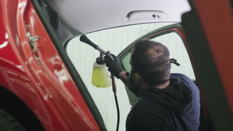 professional car cleaning. сar wash. interior detailing. dry clean and detail a car interior. deep seats cleaning. wiping foam in car wash. cleaning the car panel from dust. a vacuum cleaner