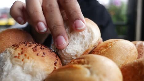 person eating bread rolls