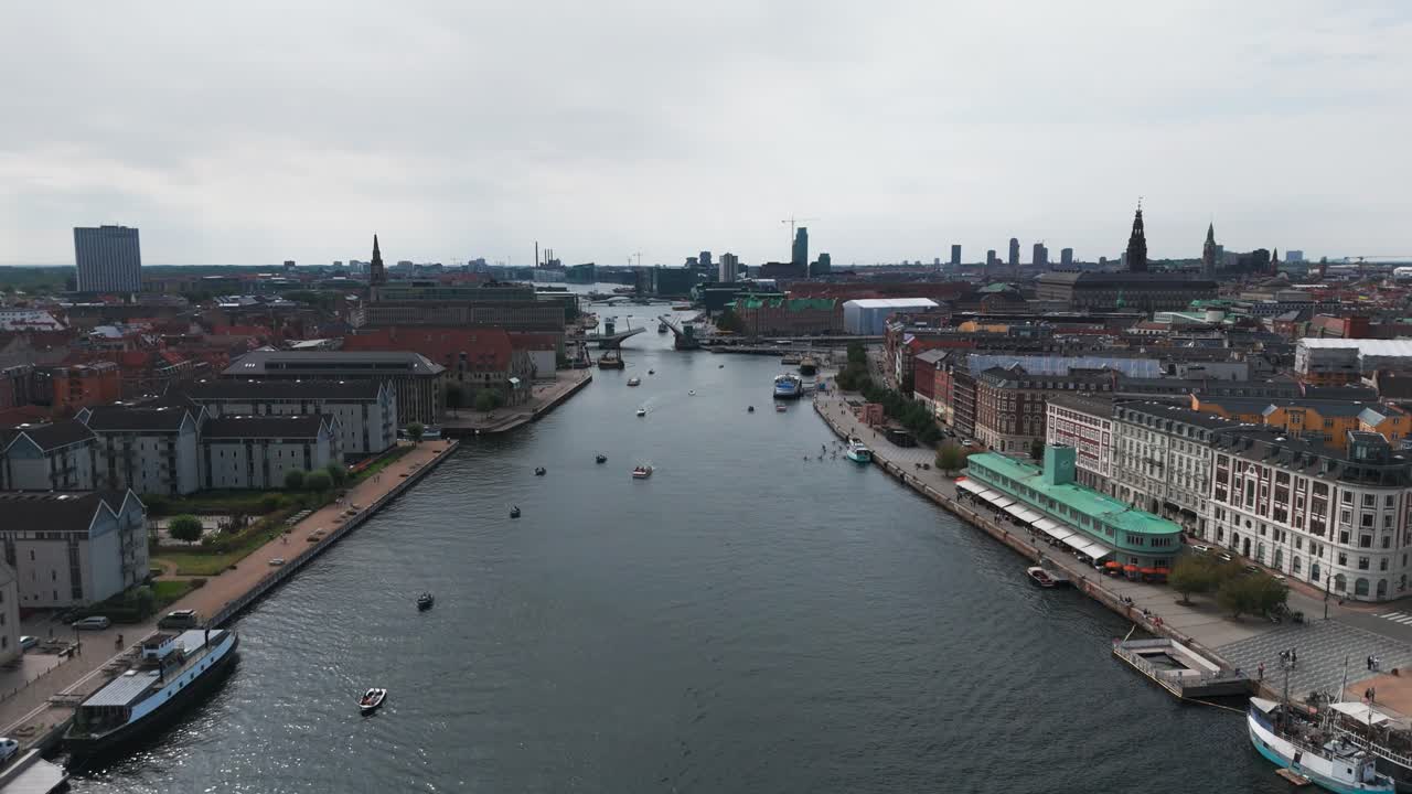 Aerial - river canal in Copenhagen with buildings in shore, Denmark