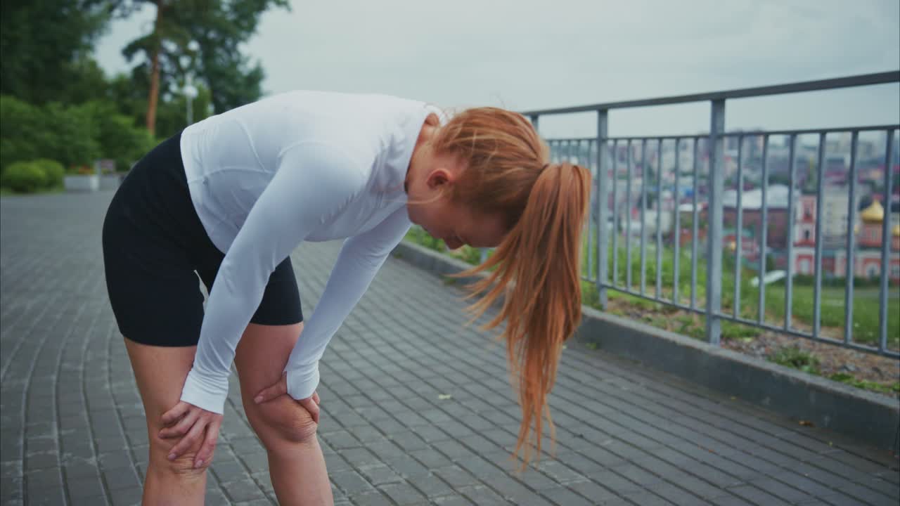 Exhausted woman resting after running workout