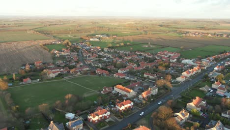 sunset over pretty yorkshire village in the middle of the countryside with views of fields for miles