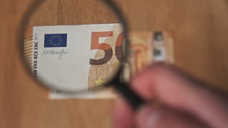 fifty euro under magnifying glass