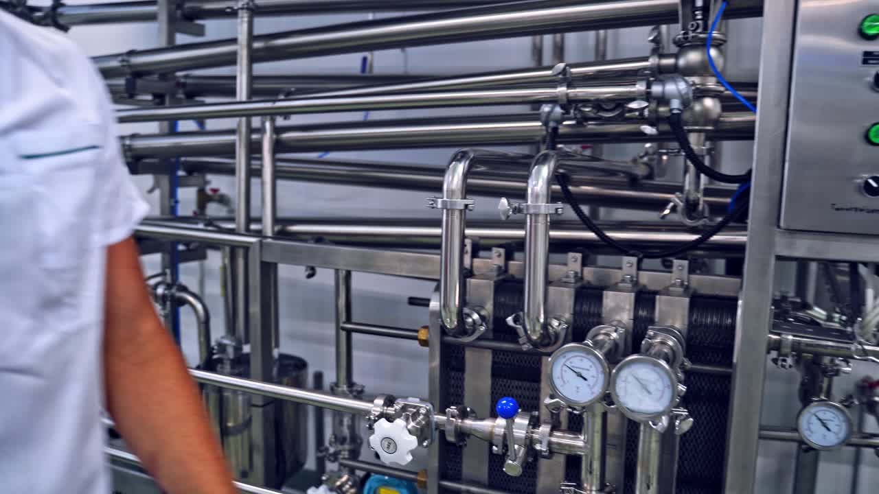 Milk factory production. Automated mechanized milking equipment closeup for farmland industry