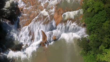 Cinematic-downward-angle-drone-shot-of-of-the-waterfalls-found-at-Cascadas-de-Agua-Azul-on-the-Xanil-River-in-Chiapas-Mexico