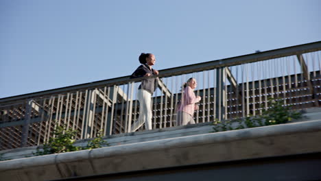 friends, women running at bridge in city