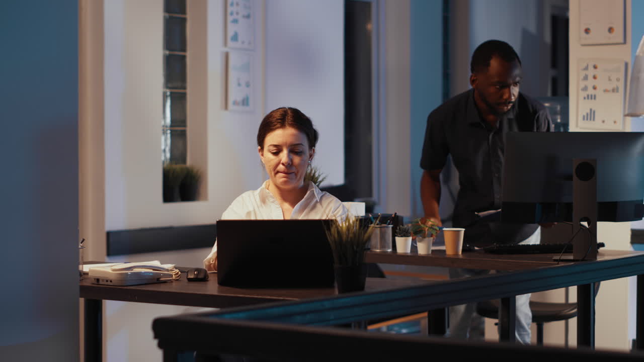 Manager using e commerce and sales data on laptop at night