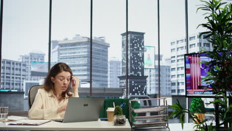 stressed woman entrepreneur suffering form a migraine from workload and fatigue