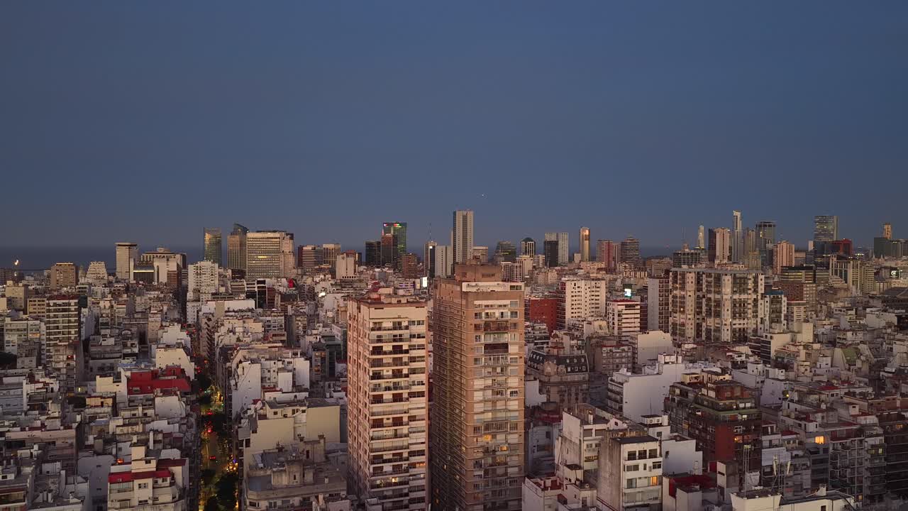 Aerial panoramic view of Buenos Aires at sunset with warm light over buildings and a calm evening cityscape