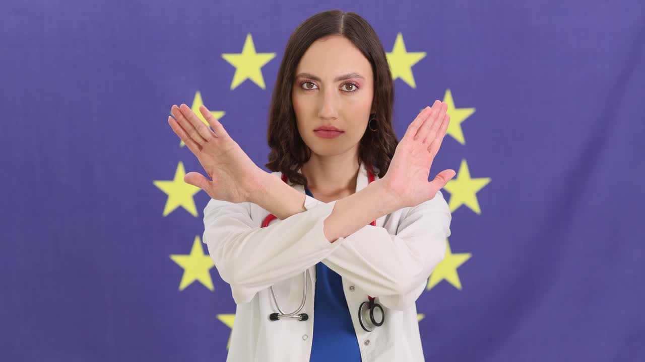 Doctor making a 'stop' gesture with crossed arms in front of the European Union flag