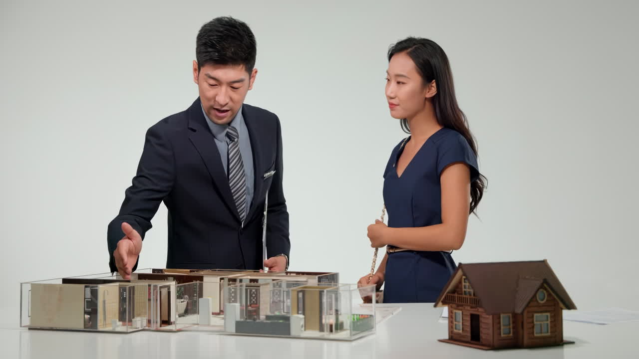 Real estate professional architects and financial experts gathering around a table to discuss and plan a new real estate development project strategy doing paperwork in office