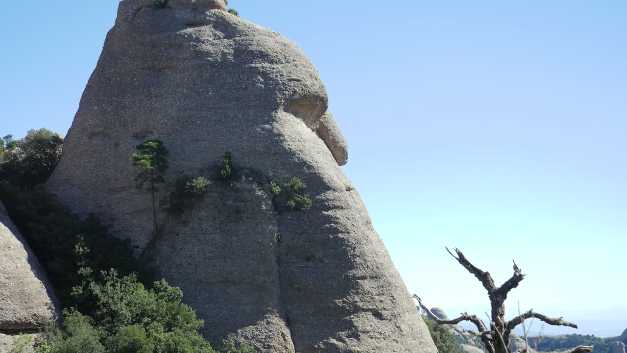 A natural rock formation in Montserrat resembling a human face in profile. The "Forehead," "nose," and "chin" are clearly visible against a bright blue sky